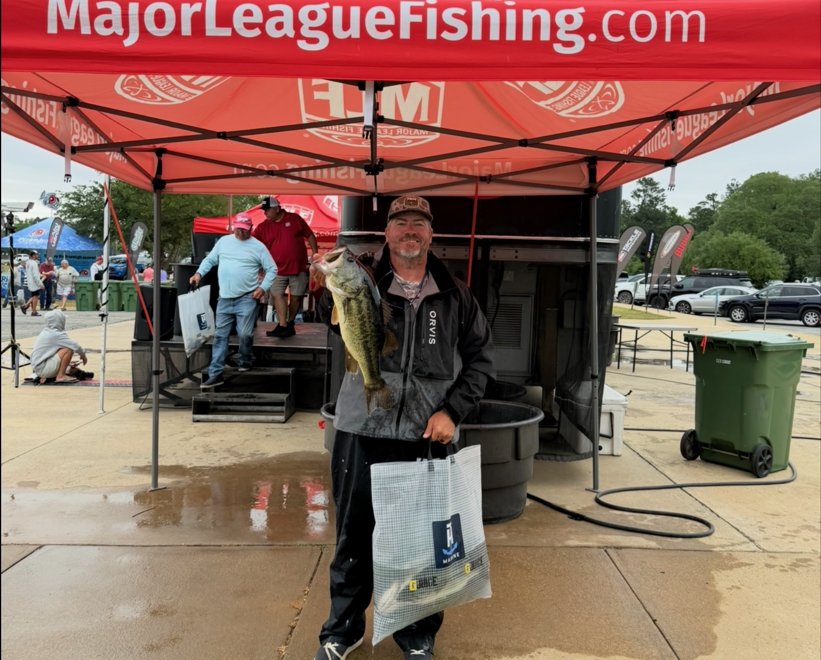 Ashley Brown with a bass at a fishing tournament