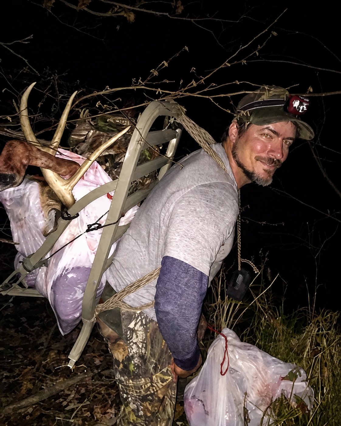 Ashley Brown carrying a deer out after a hunt